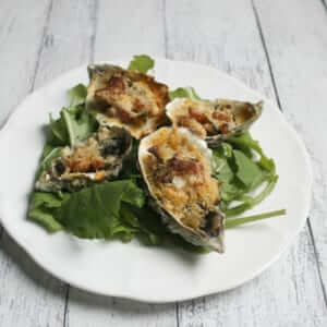 Baked Oysters loaded with arugula and bacon