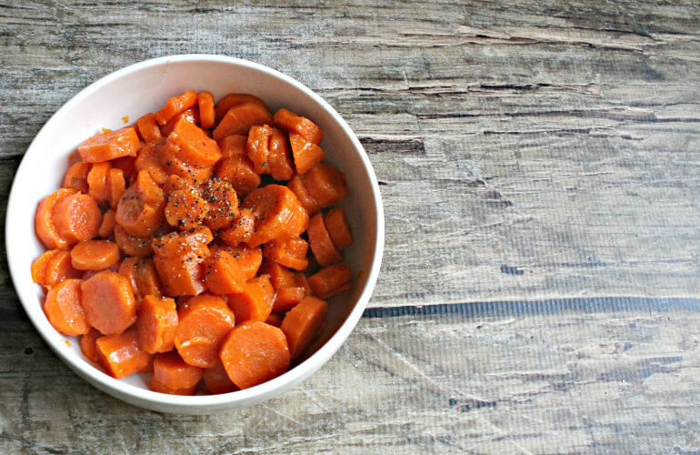 Paleo Buttery Maple Carrots in a white bowl
