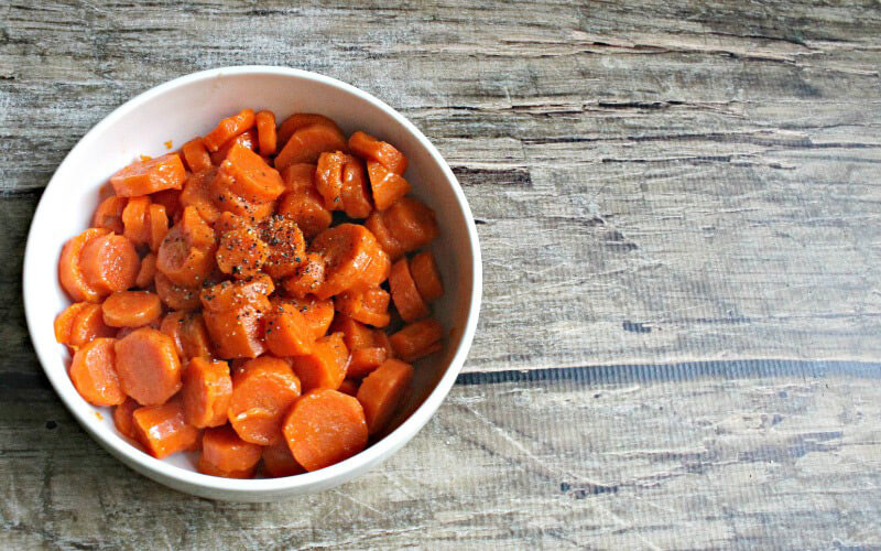 Paleo Buttery Maple Carrots in a white bowl