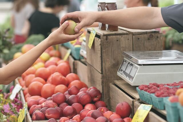 farmers market stand with fresh vegetables and fruit