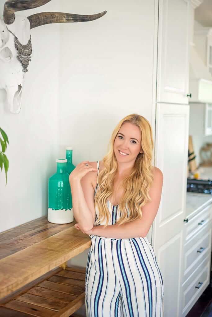 Picture of a woman in a striped dress standing in her kitchen