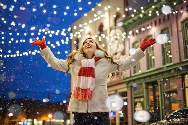 a girl admiring the Christmas decoration in the streets 