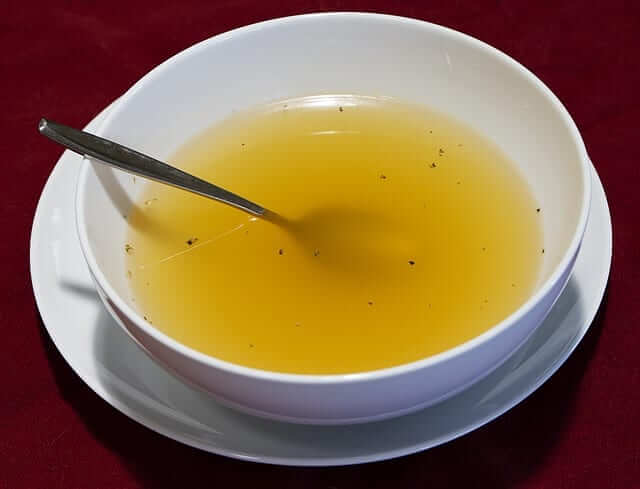 homemade chicken bone broth in a soup bowl