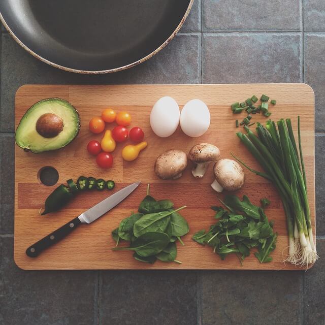 vegetables on a wooden cutting board ready for healthy holidays meal prep