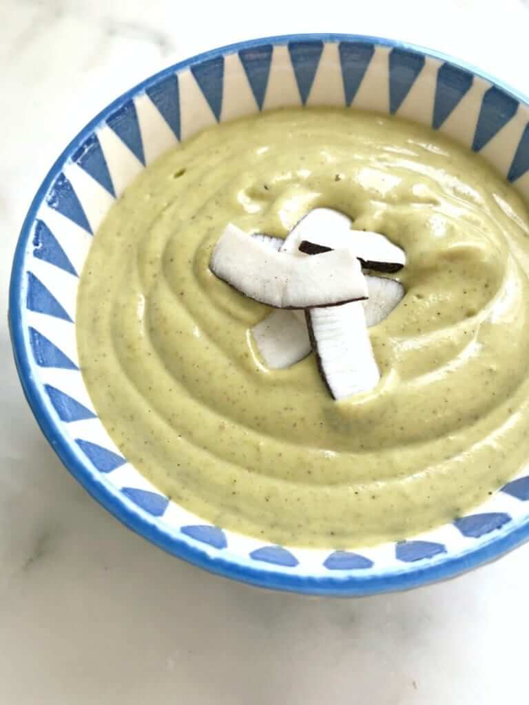 close-up of a bowl of pistachio keto pudding in a blue bowl