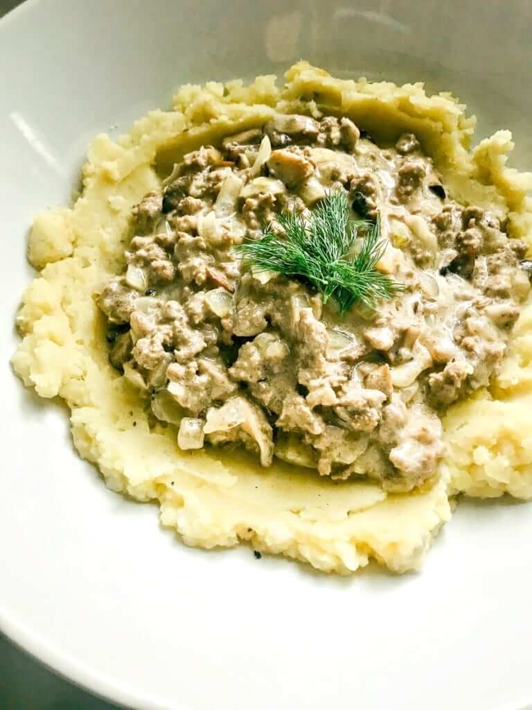 overhead shot of ground beef stroganoff in a white plate