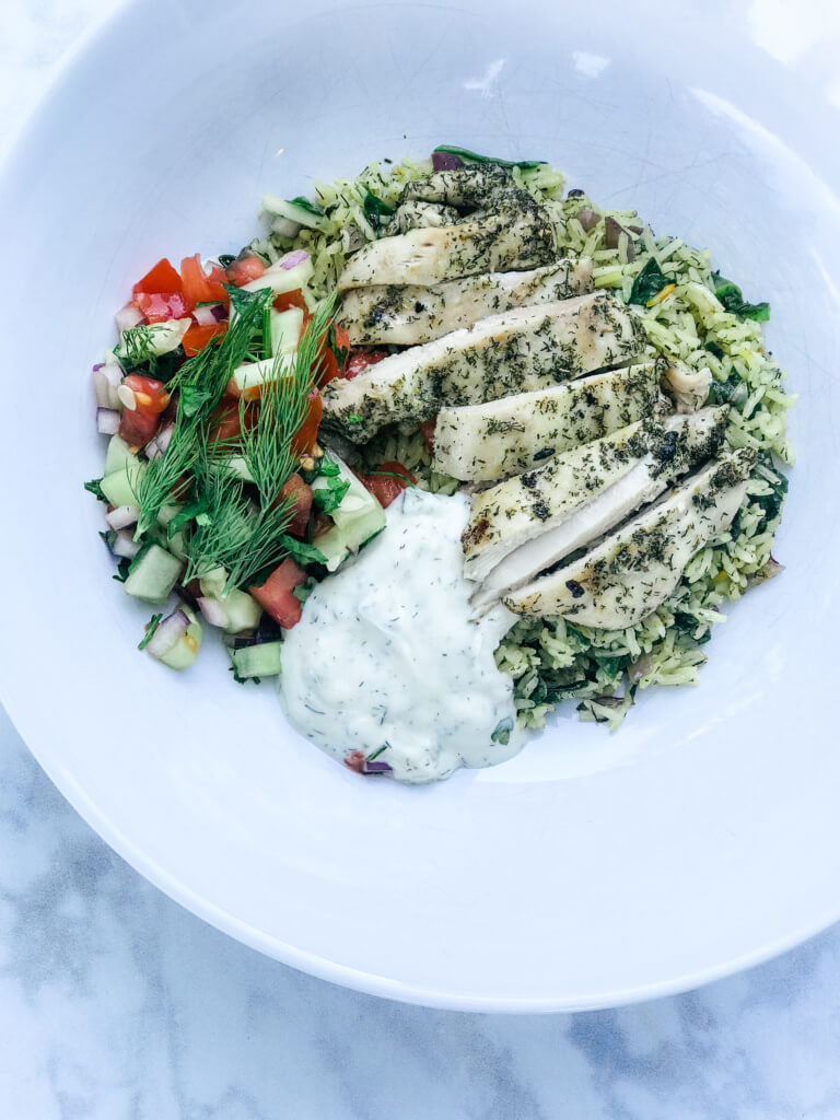 overhead shot of a paleo Greek marinated grilled chicken and rice bowl
