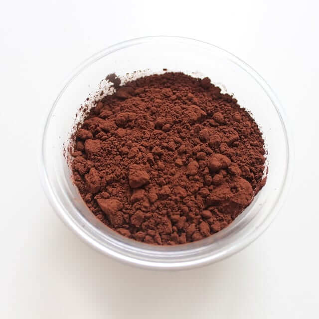 a small glass bowl with raw cacao powder 