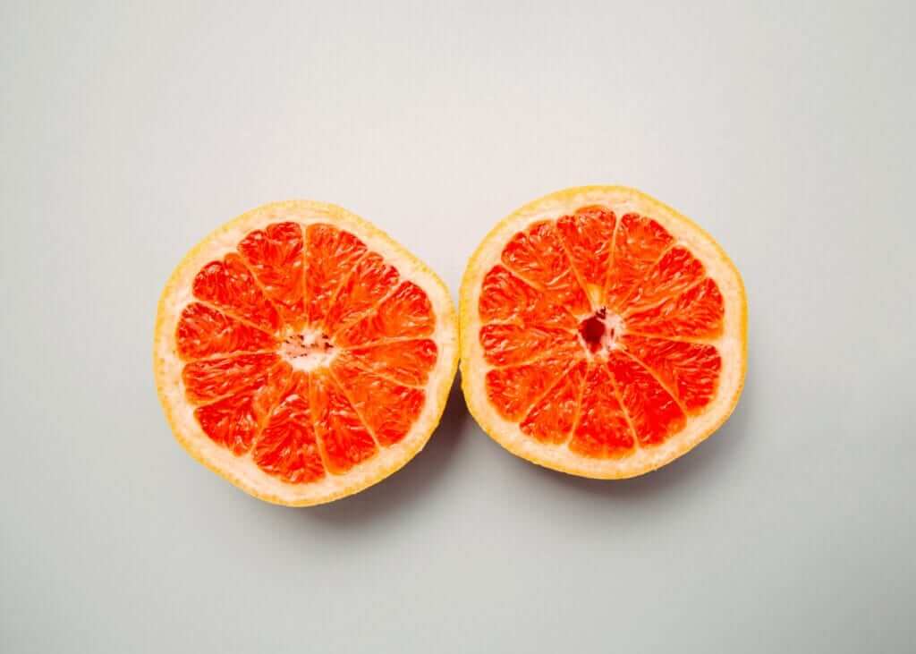 two round slices of ruby red grapefruit placed next to each other