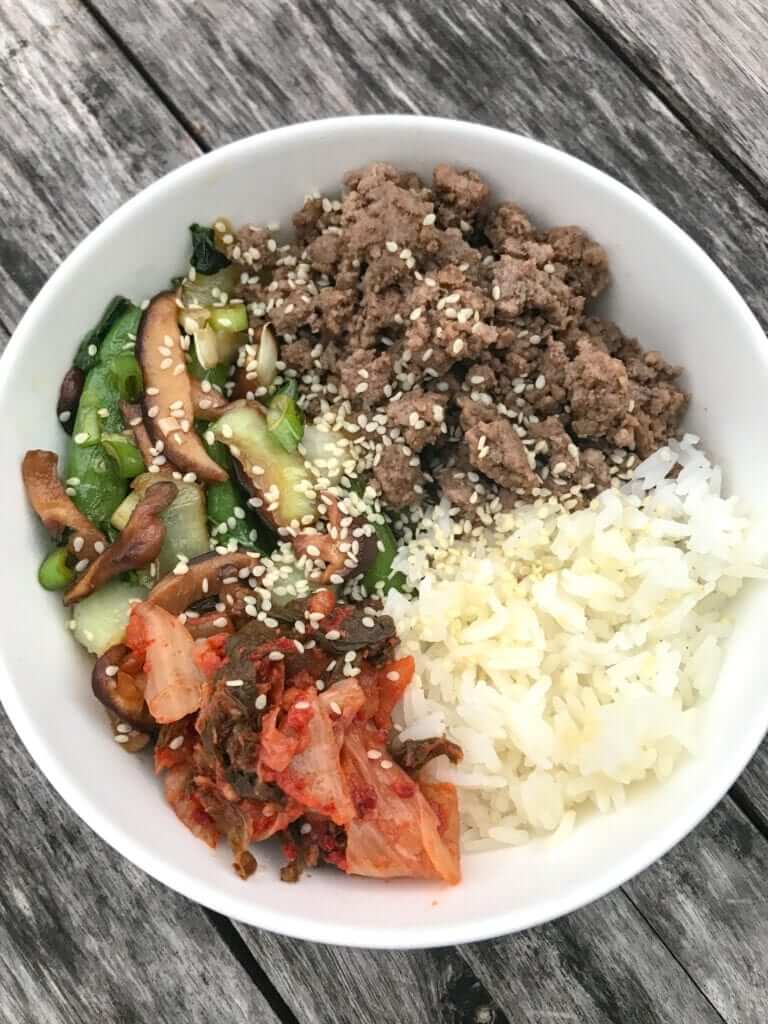 overhead shot of an Asian Beef Bowl with veggies served with white rice as a side