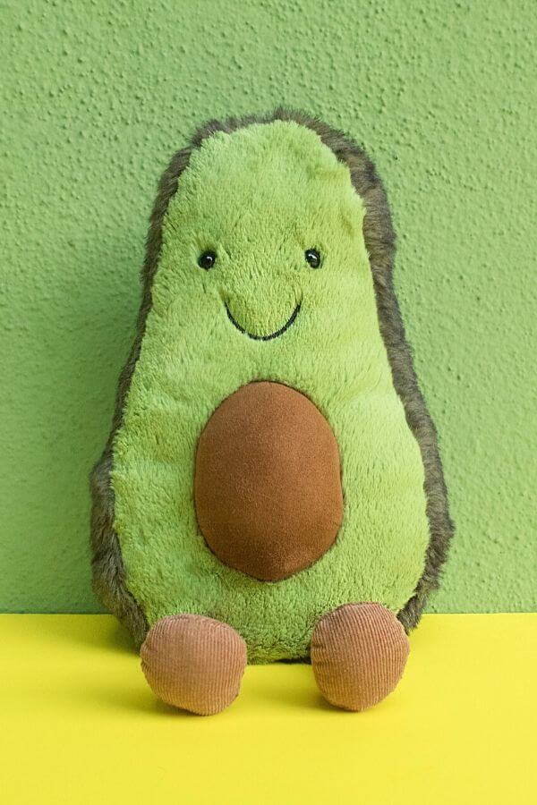 a smiling toy avocado representing good gut health 